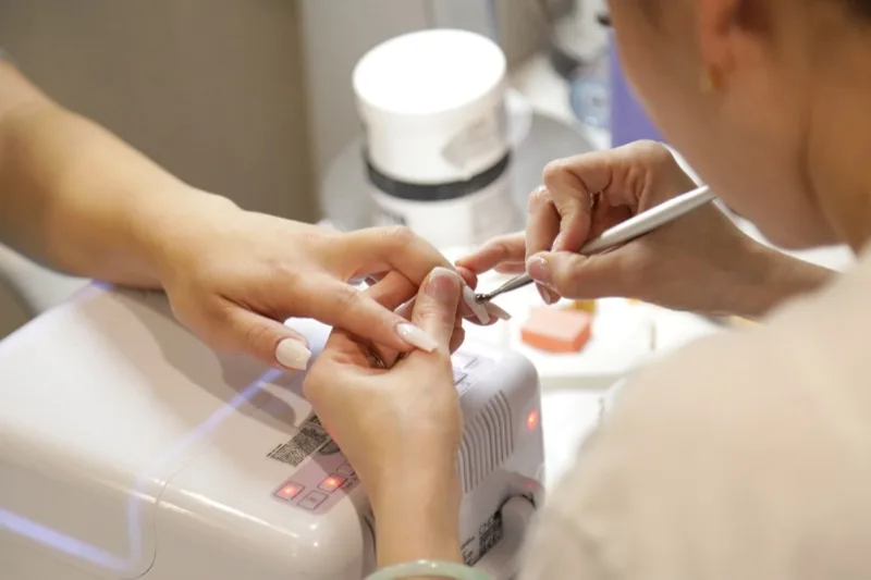 Nail technician performing a manicure