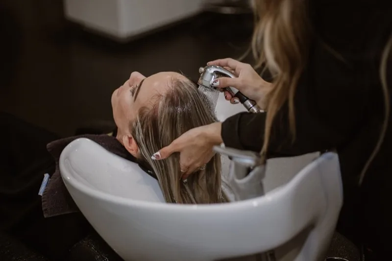Client receiving a relaxing shampoo service at Studio 53 Salon and Day Spa